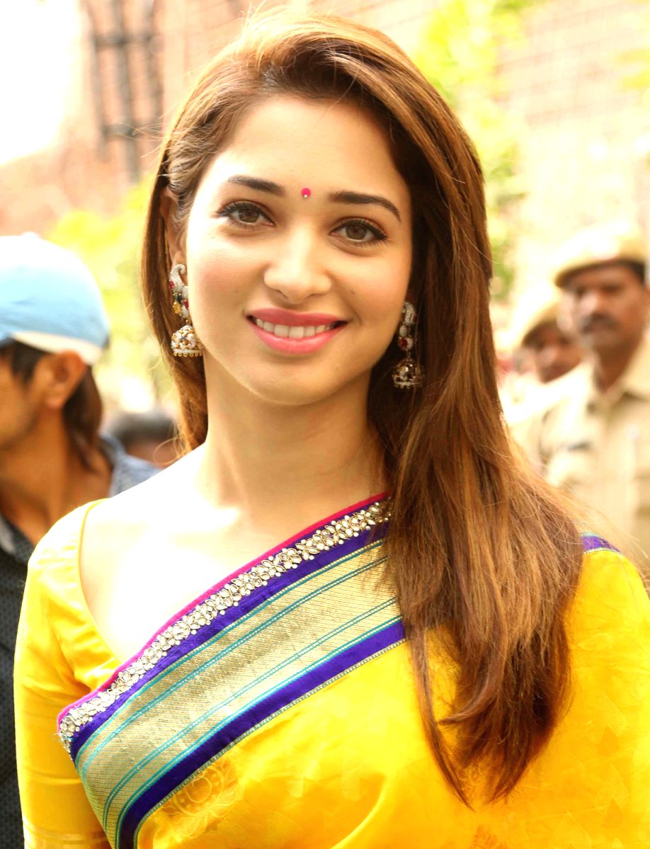 Tamannaah looks like the morning sun in this bright yellow saree and traditional Bhindi with some lovely Jhumkas