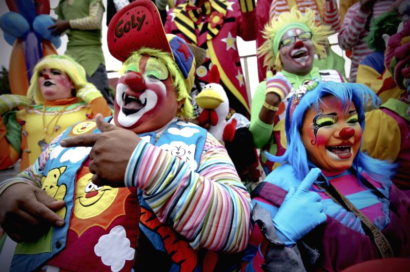 Clowns participate in the "15 minutes of laughter" during the 18th International Clown Convention, in Mexico City, capital of Mexico, on Oct. 23, ...